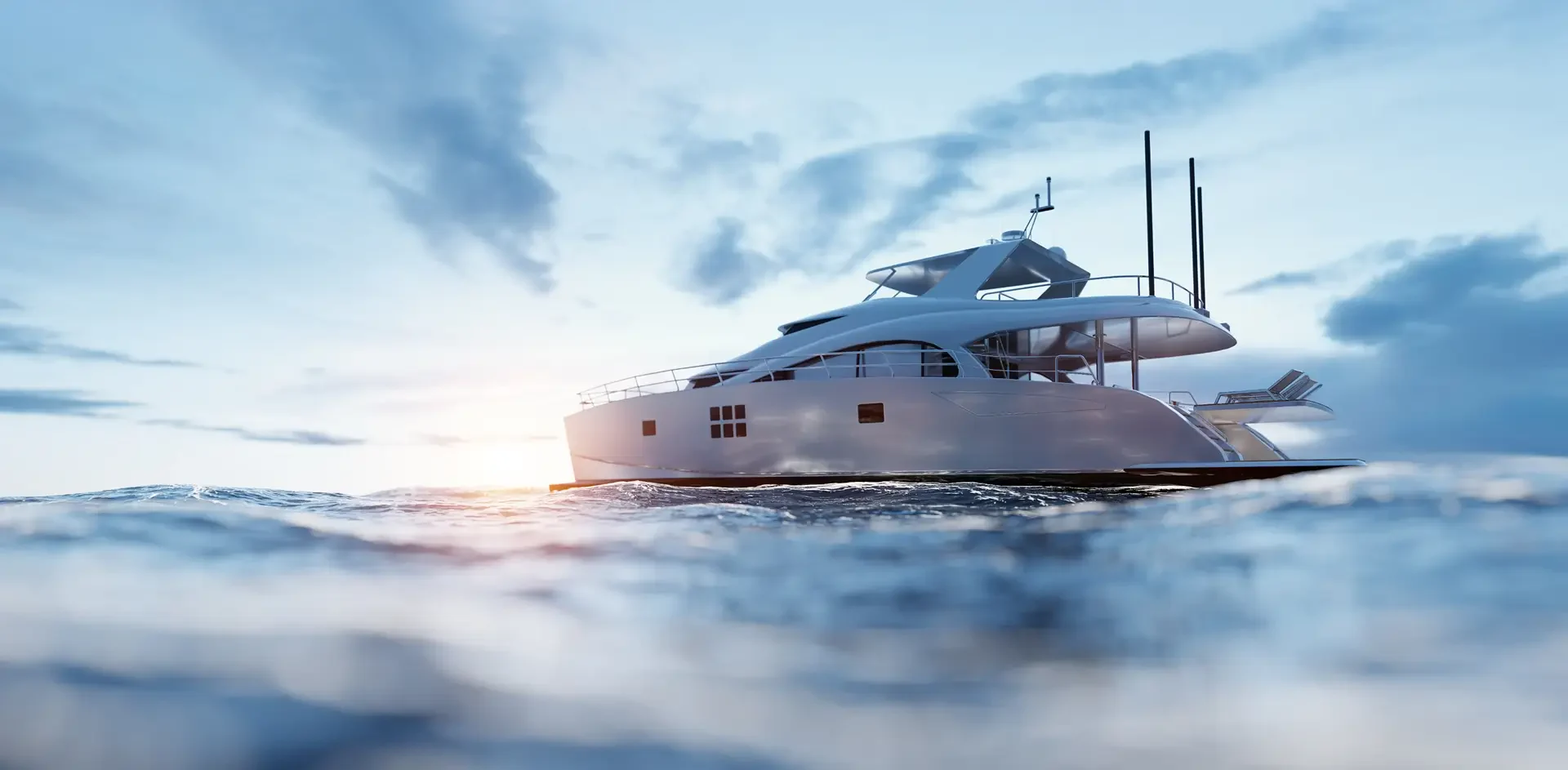 A sleek white yacht glides over tranquil waves under a bright sky, with sunlight glinting off the water's surface.
