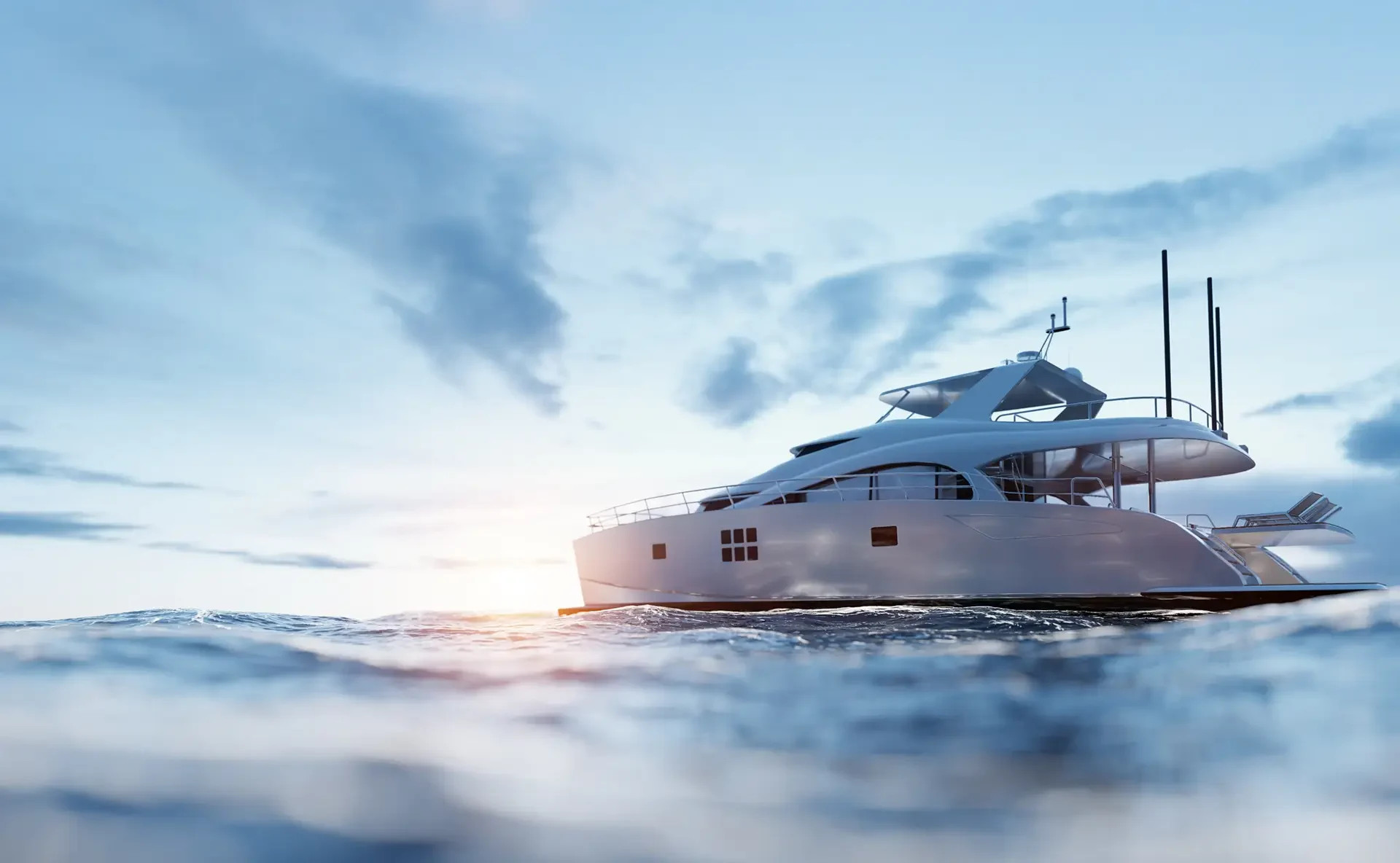 A sleek white yacht glides over tranquil waves under a bright sky, with sunlight glinting off the water's surface.